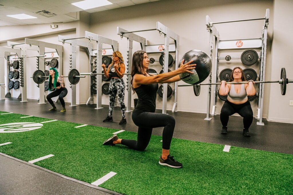A woman doing strength training with Gymrax equipment in a condo gym. 