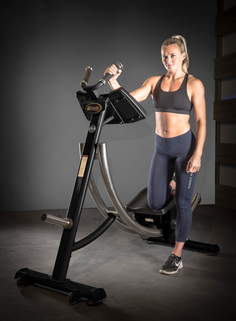 A woman poses on a an Ab Coaster.